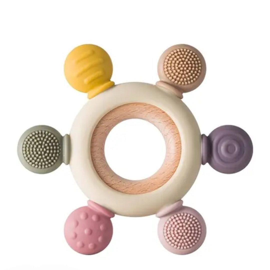 Colorful baby teething ring with various textured nodes on a white background