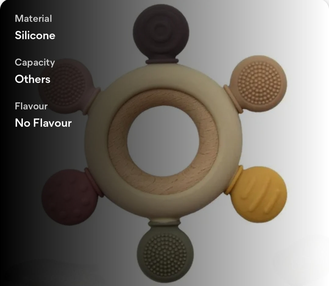Silicone teething ring with various textures on a gray background